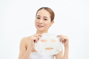 Portrait of young beautiful Asian woman holding face mask isolated on white background.