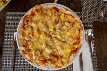 Hawaiian Pizza homemade in the white dish for served, lunch meal