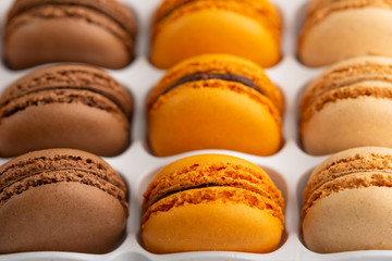 background with an assortment of colored french sweets macaroon, selling a shop or cafeteria, restaurant. Tastes and sweets