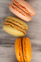 close-up of colored french macaroon, sweets with colored caramel sweets.Tasties and sweets, vertical frame