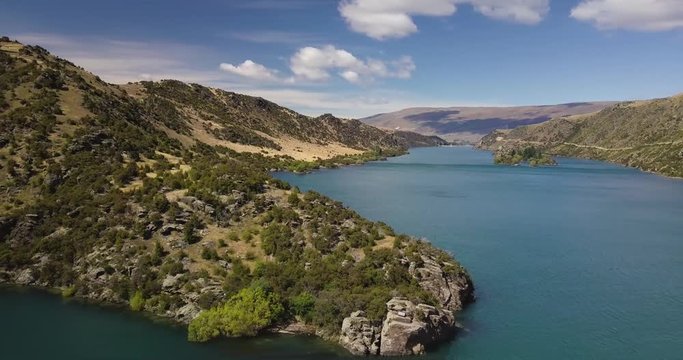 Drone shot of a lake in New Zealand. Beautiful weather, clear water and smoth motion. Very nice colors of nature.