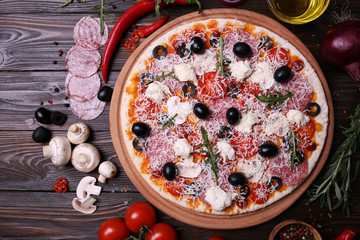 Italian pizza with the best products, with tomatoes, mozzarella cheese, mushrooms and olives,salami