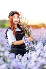 Portrait of teenage girl in a garden of flowers, Young happy asian girl in Margaret Aster flowers field in garden at Chiang Mai, Thailand