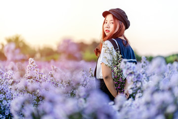 Portrait of teenage girl in a garden of flowers, Young happy asian girl in Margaret Aster flowers...
