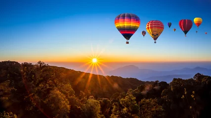  Colorful hot air balloons flying over mountain at Dot Inthanon in Chiang Mai, Thailand. © somchairakin