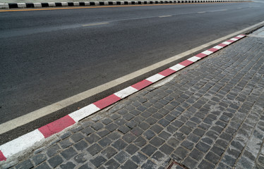 Fototapeta premium Road with red and white curb