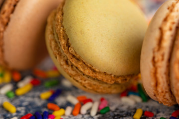 Macro, close-up of colored french macaroons, sweets with colored caramel sweets.