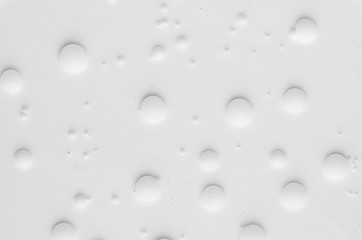 Fototapeta na wymiar White liquid paint texture with round bubbles different sizes as simple abstract background.