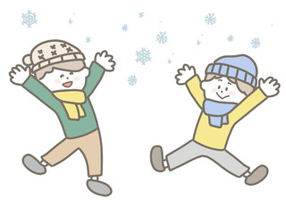 Fototapeta premium Boy playing happily on snowy day