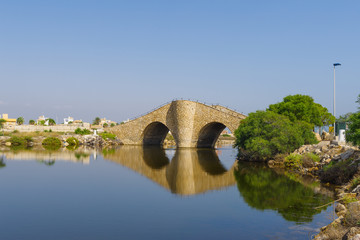 Fototapeta na wymiar View on the canal in Mar Menor and an interesting arched bridge 