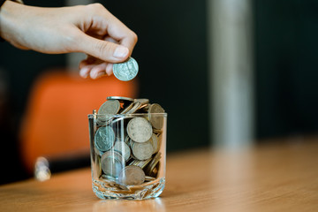 saving money with putting coins in glass, finance accounting concept