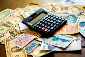 Calculator on multi currency banknotes.