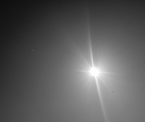 abstract background with stars, black and white photography of sun shining in the sky