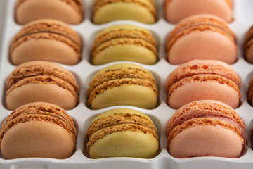 background with an assortment of colored french sweets macaroon, selling a shop or cafeteria, restaurant. Tastes and sweets