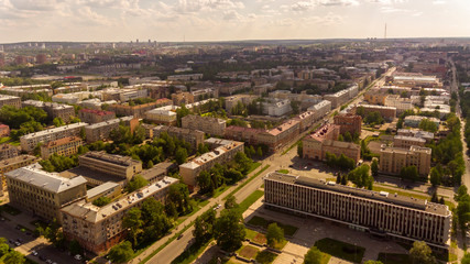 Fototapeta na wymiar Aerial panorama of houses and avenues of city downtown in summer