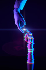 Touching fingers of engineer and digital technology that he creates. Acquaintance of man and...
