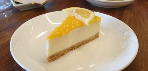 lemon cheese cake piece on the table in the cake  