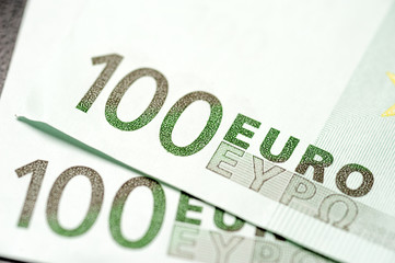 Two hundred euro bills lies in each other.