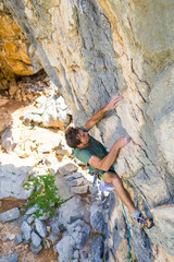 rock climber climbs a rock
