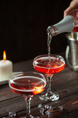 Two glasses of  champagne on dark wooden background. Festive drink. Valentins or Christmas concept.