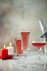 Two glasses of  champagne on dark wooden background. Festive drink. Valentins or Christmas concept.