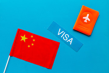 Visa to China concept. Chinese flag near passport on blue background top-down copy space