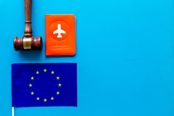 Visa to Europe concept. European flag near passport and judge hammer on blue background top-down copy space