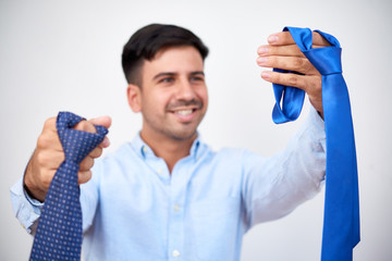 Smiling young entrepreneur choosing necktie for the working day