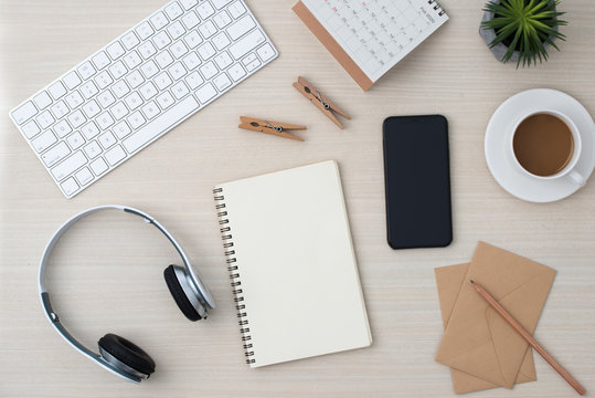 Desk of musician for songwriter work with headphones and smartphone on color background top view mockup