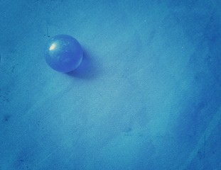 Blue glass ball with a blue background