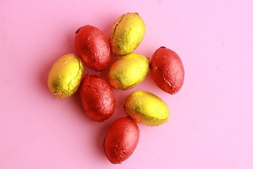 chocolate easter eggs, wrapped in yellow and red paper