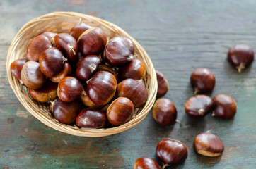 Edible chestnuts on the  wooden table.