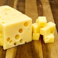 Piece of cheese close-up. cheese on a wooden board