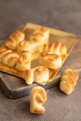 Spanish Christmas marzipan sweets, Figuritas de mazapan with christmas decoration on wooden cut board. Traditional treat consumed during winter holidays in Spain.