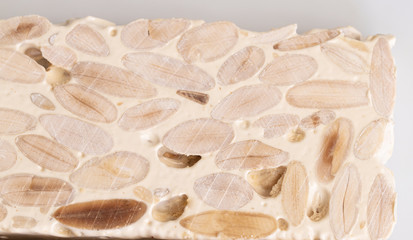 Close up of Turron duro or The nougat of Alicante, also called hard nougat. Detail background
