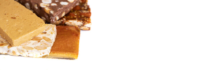 Variety of Spanish turron or nougat, Typical sweets consumed at Christmas time in Spain. Hard almond, soft almond, chocolate and burnt egg yolk nougat.