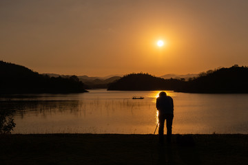 Unidentified sIlhouette photographer shooting photo