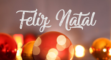 Christmas greetings with portuguese text Feliz Natal (merry christmas) and Christmas baubles