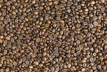 Coffee beans background top view. Arabica strong roast.