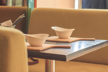 Retro style dining room interior details. White plate on the table