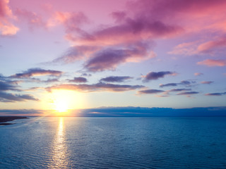 Sunset over the sea. Sea landscape in the evening. Beautiful sunset with dramatic sky. Aerial view