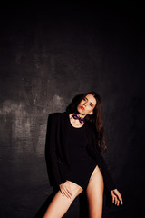 sexy girl in underwear and jacket is black wall