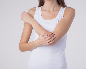 Woman with pain in elbow, joint inflammation isolated on white background