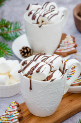 Hot vanilla chocolate in a white cup with marshmallows and chocolate glaze. Hot Christmas drink. Winter drink.