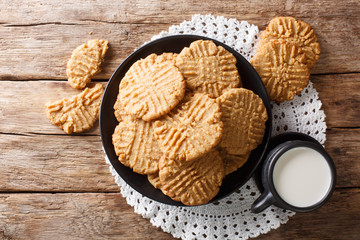 Breakfast of peanuts butter cookies with milk close-up. Horizontal top view