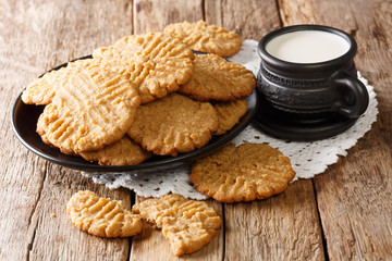 Peanut butter recipe cookies served with milk close-up. horizontal