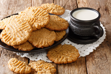 Breakfast of peanuts butter cookies with milk close-up on the table. horizontal