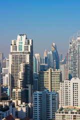 Naklejka premium Bangkok, Thailand – December 21, 2019 : Office Buildings, city and condominiums Area in Bangkok, Office Building in City, Modern Building, Businesses Building. Sky view from Asoke area. with blue sky.