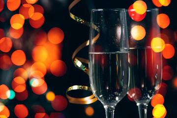 Champagne in the the glass against the background of the christmas tree, New Year Christmas. New year concept 2020