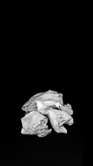 Crumpled sheet of paper stacking ,isolate with black background. Groups crumpled paper on black background. Crumpled paper bills in middle position. Crumpled paper ball isolated on a black background